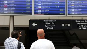 People check display screens showing cancelled flights at Lebanon's Beirut-Rafic Hariri International Airport